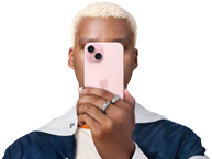 Person holding iPhone 15 in front of his face to conceal identity
